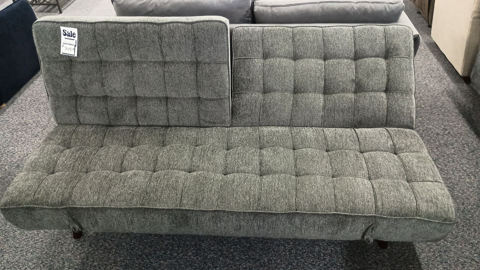 Gray tufted futon