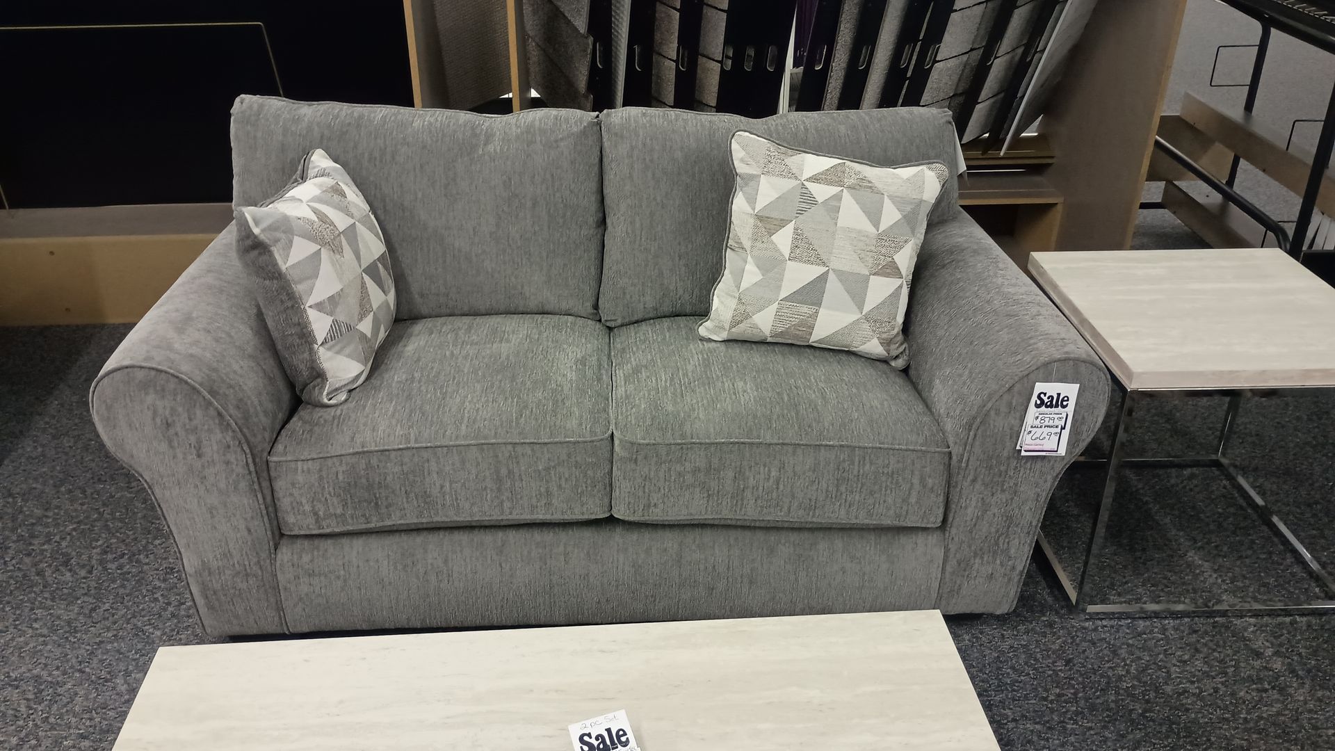 Gray loveseat with two throw pillows