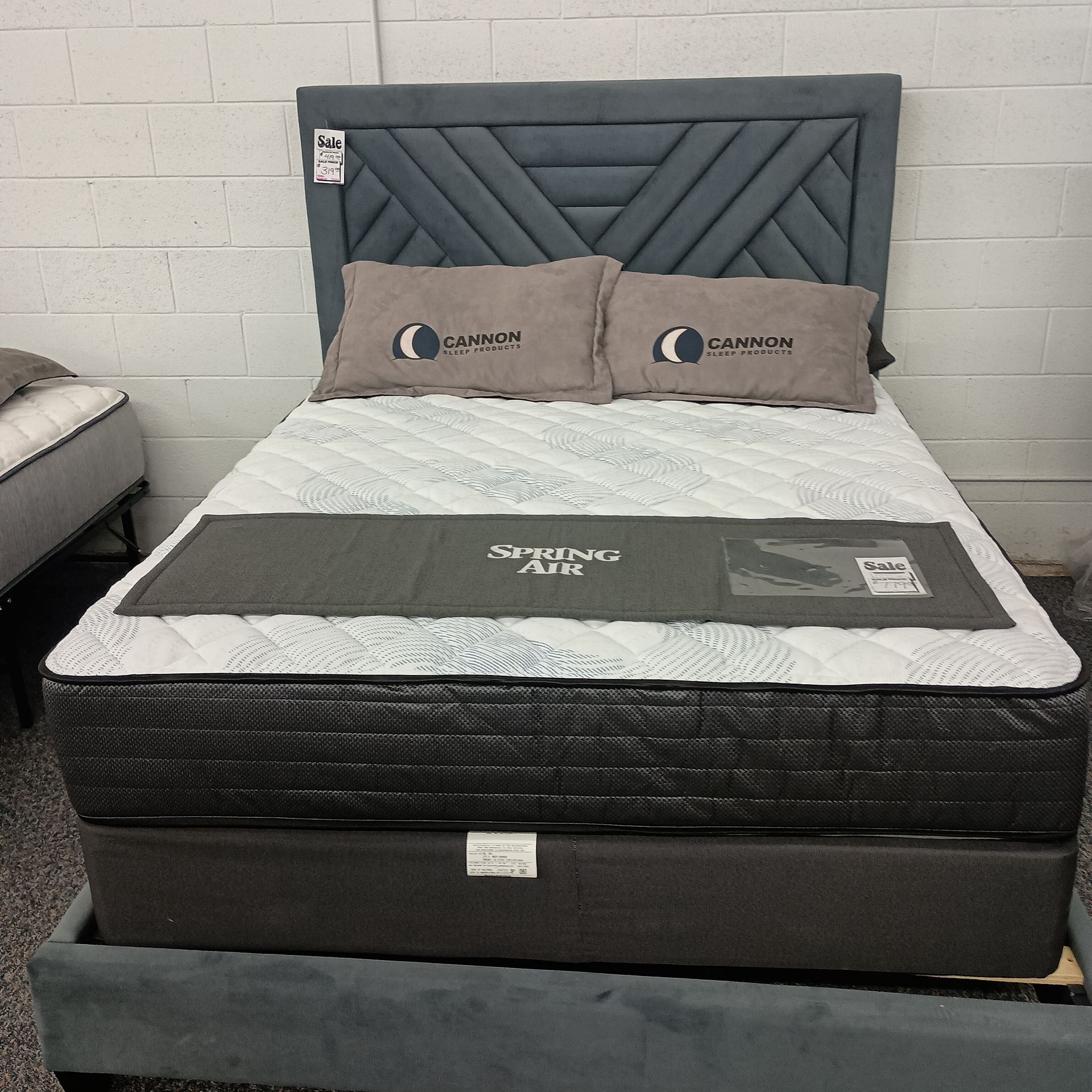 Bed with gray headboard, mattress
