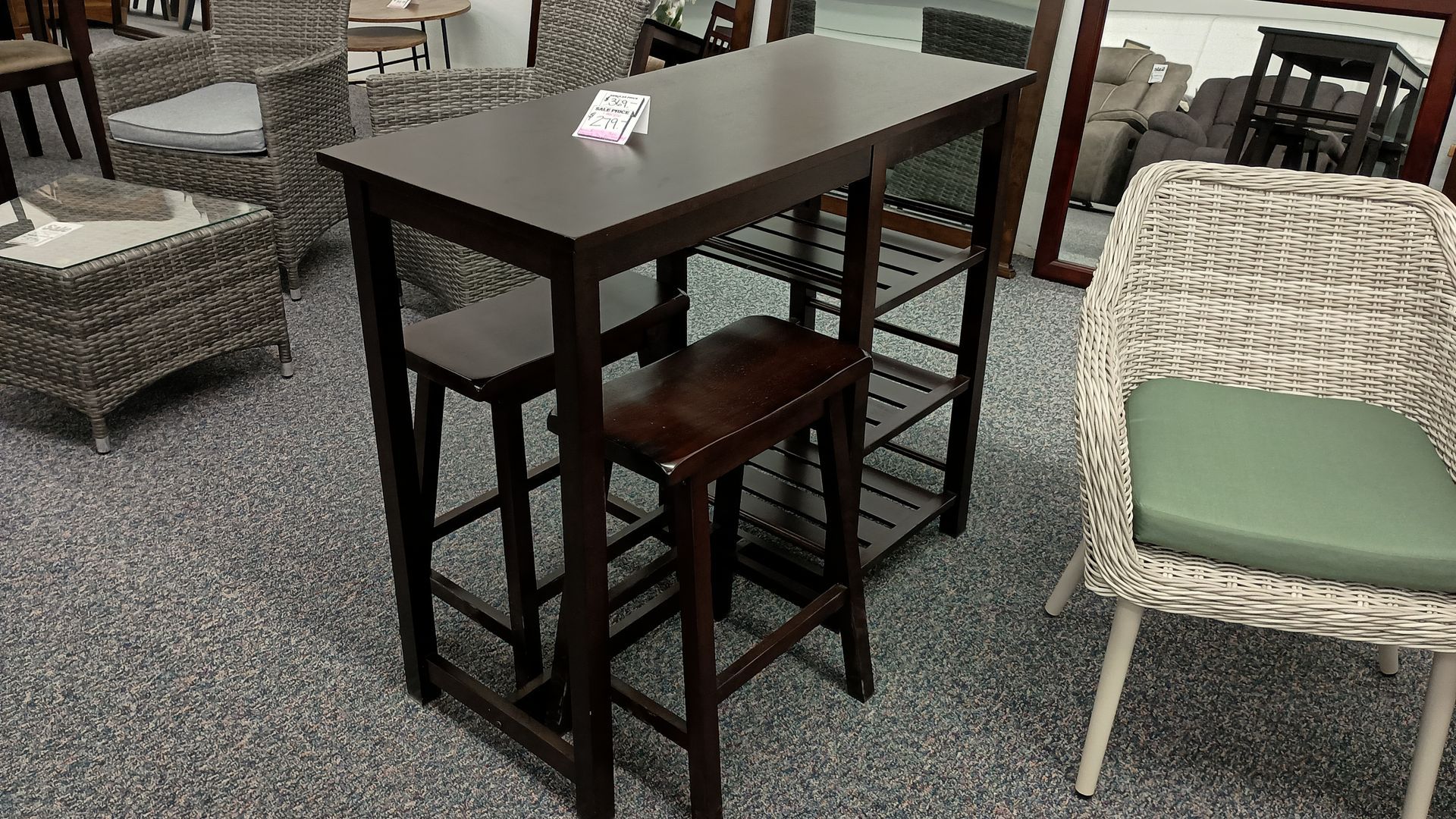 A table with two stools and a chair in a room