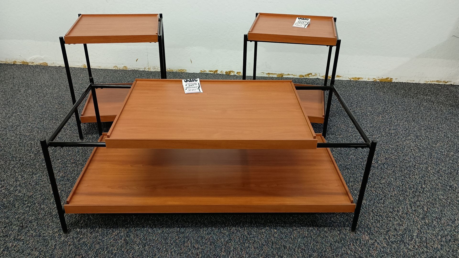 A set of three wooden shelves with a black frame