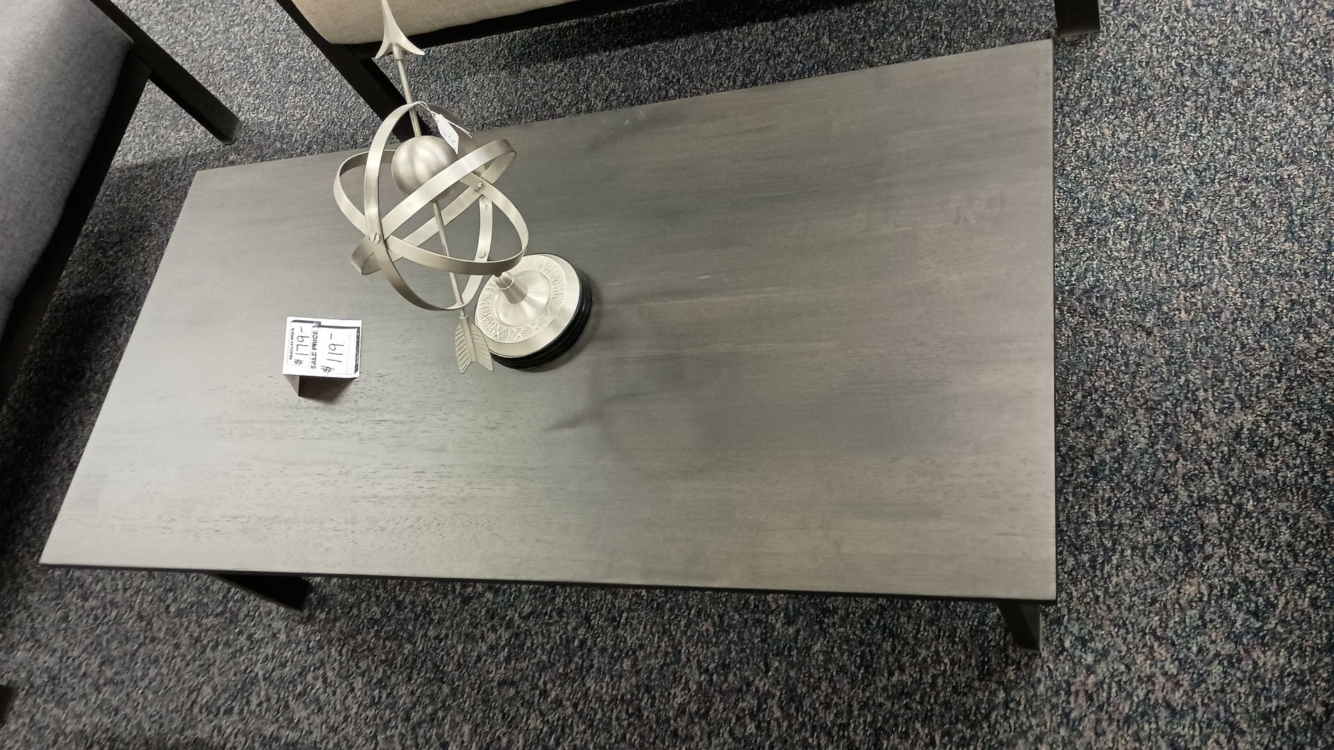 A black coffee table with a white sculpture on top of it