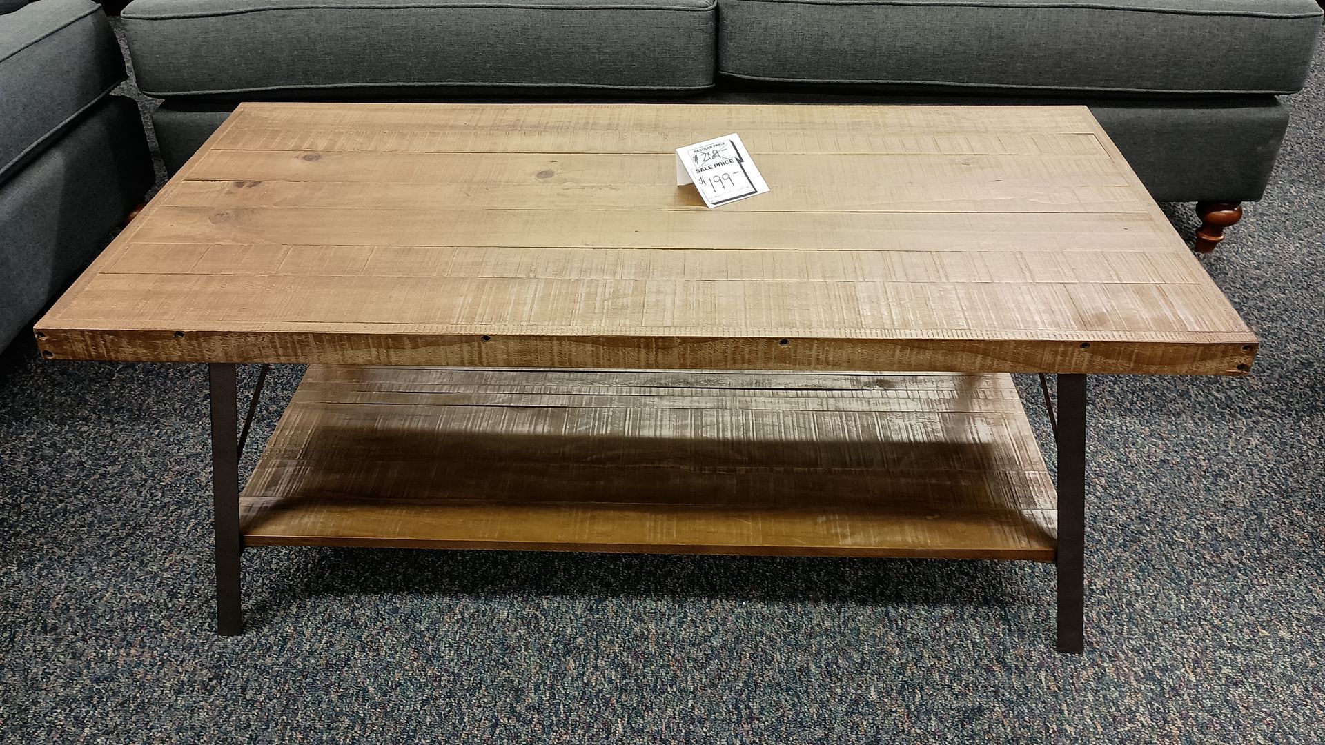 A wooden coffee table with a shelf underneath it