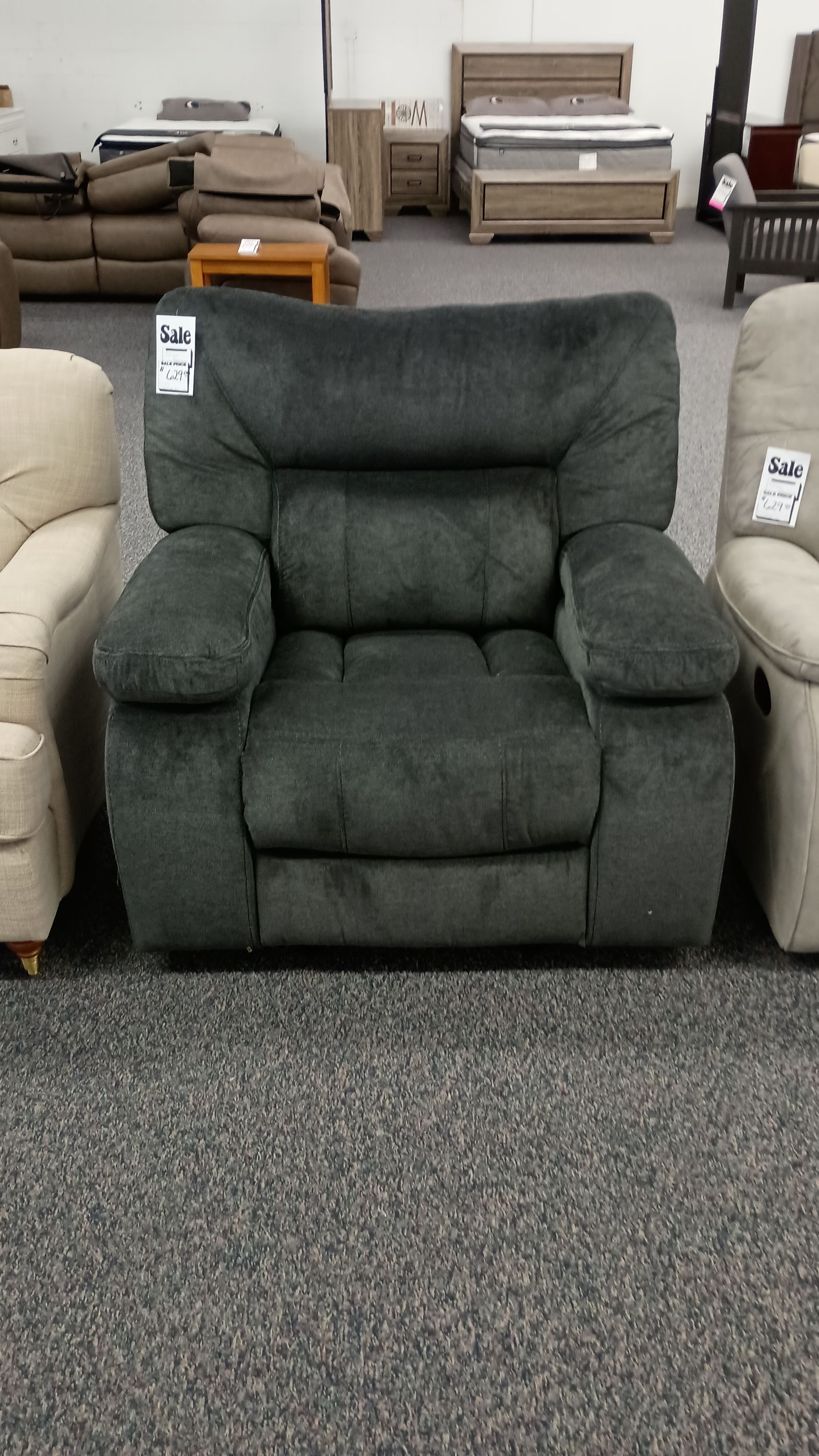 A recliner in a store with a price tag on it