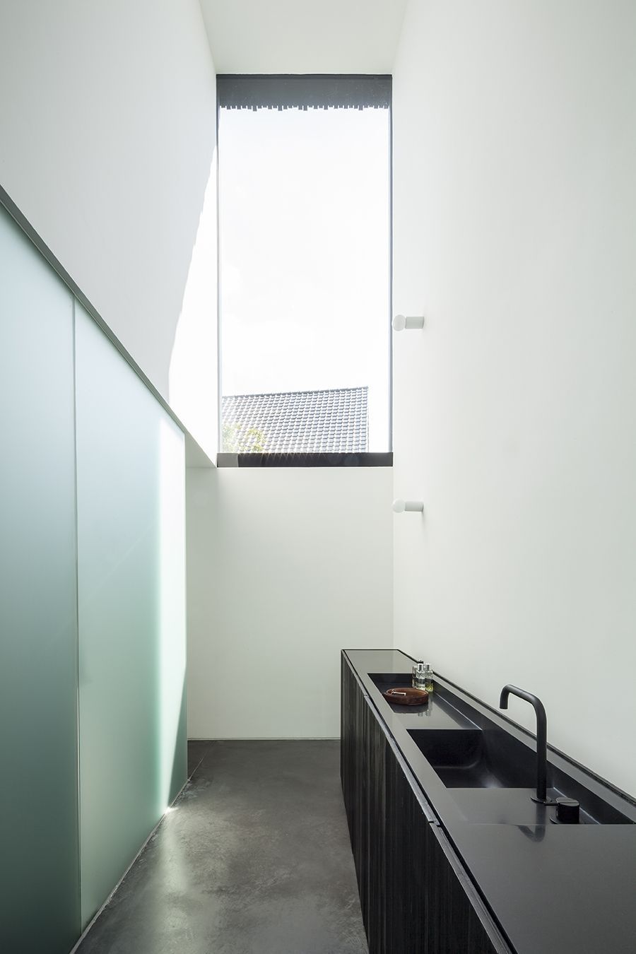 A kitchen with a sink and a large window