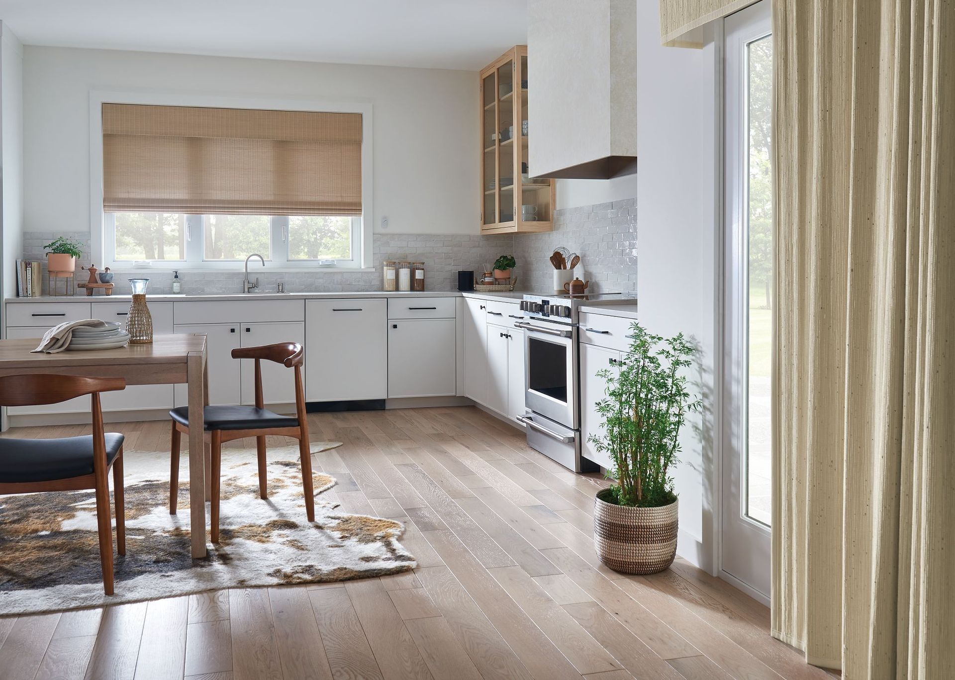 A kitchen with a table and chairs and a potted plant