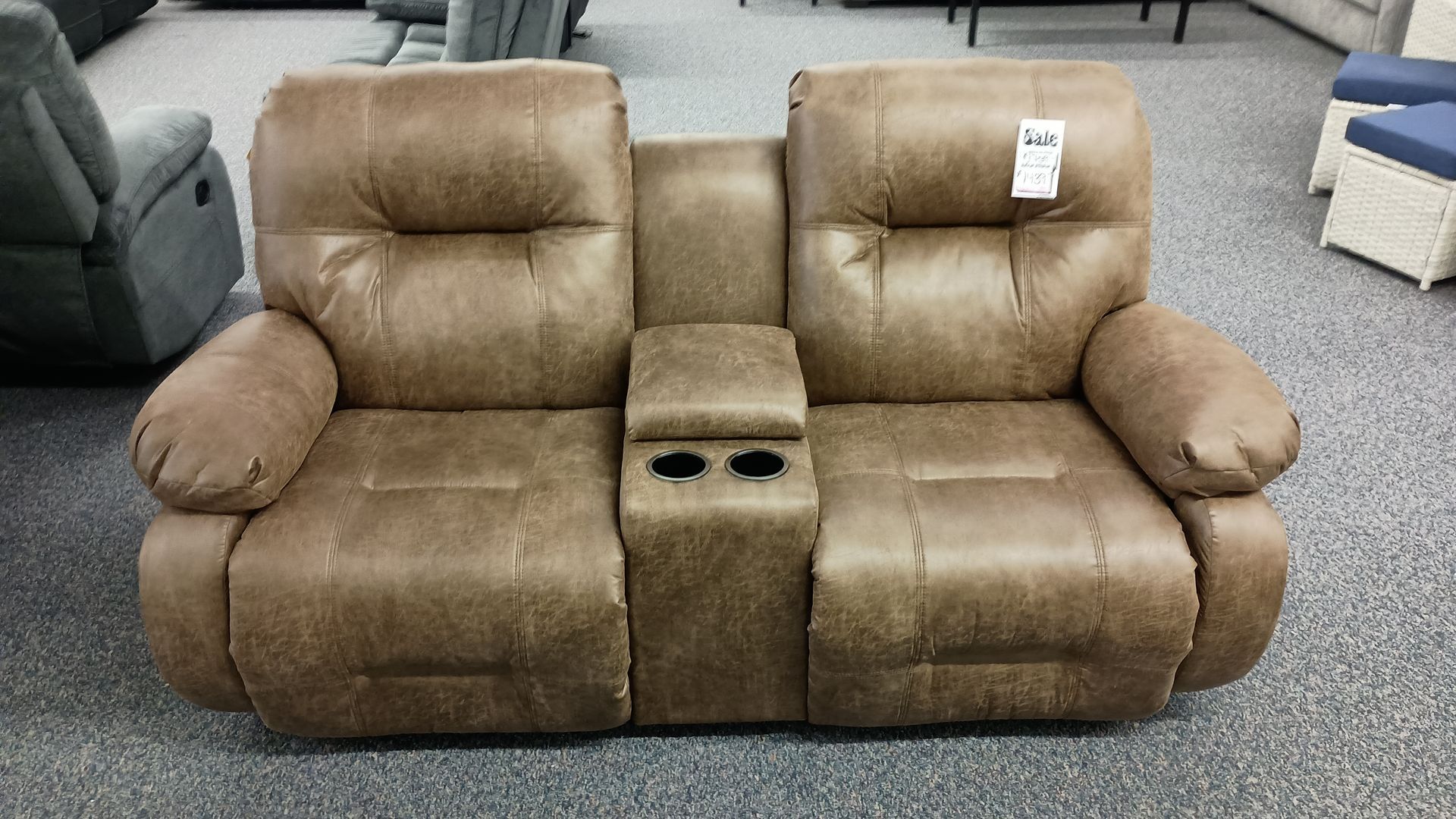 A brown recliner with a price tag on it