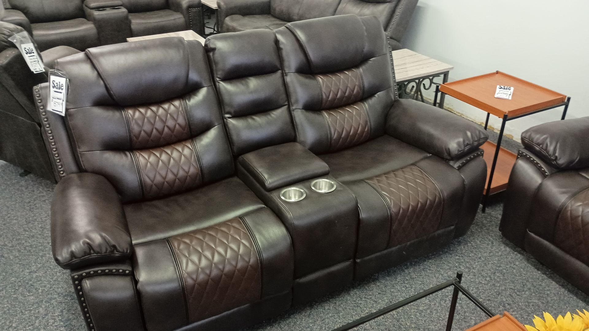 Brown leather reclining loveseat
