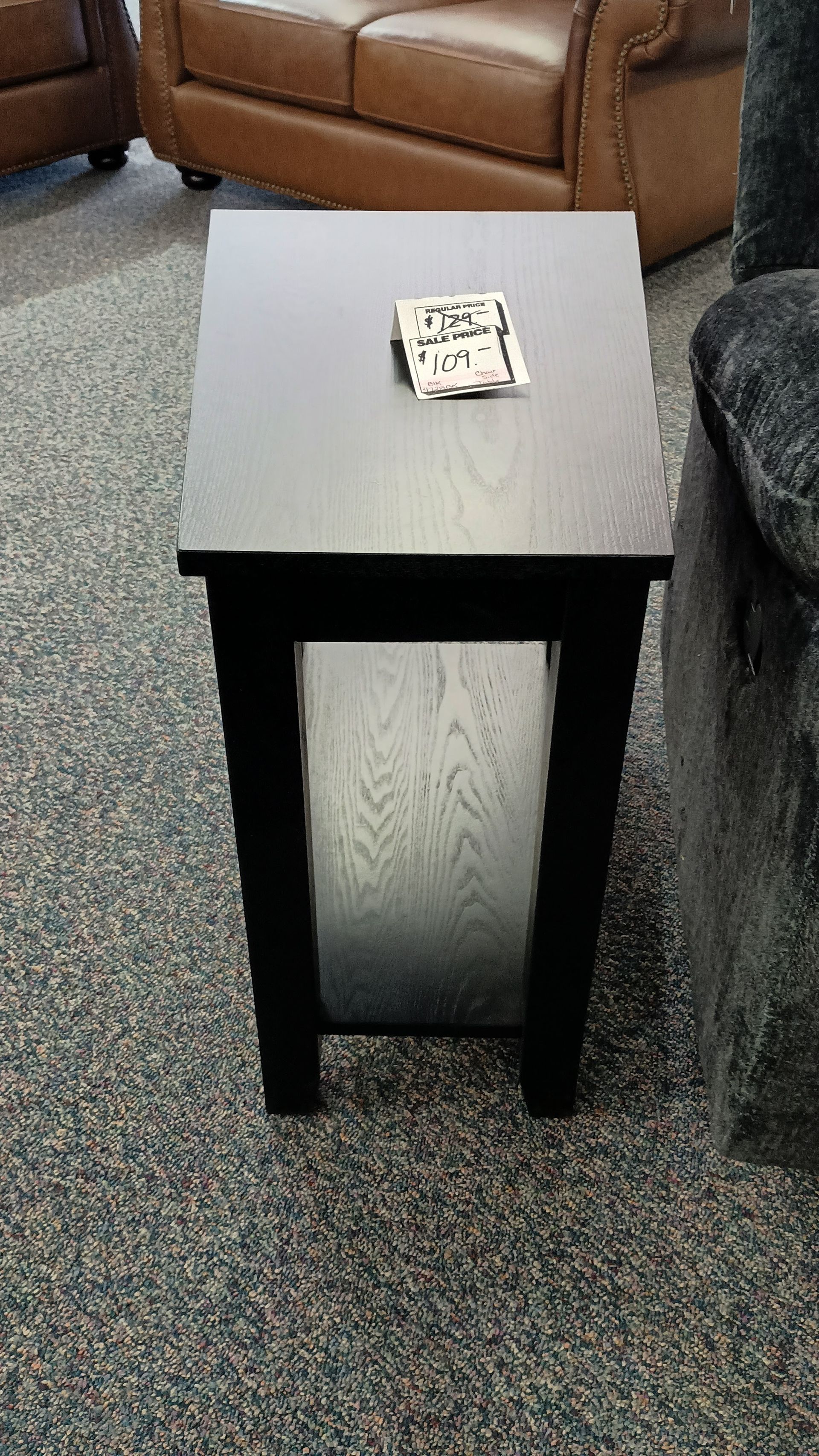 A small table with a piece of paper on top that says