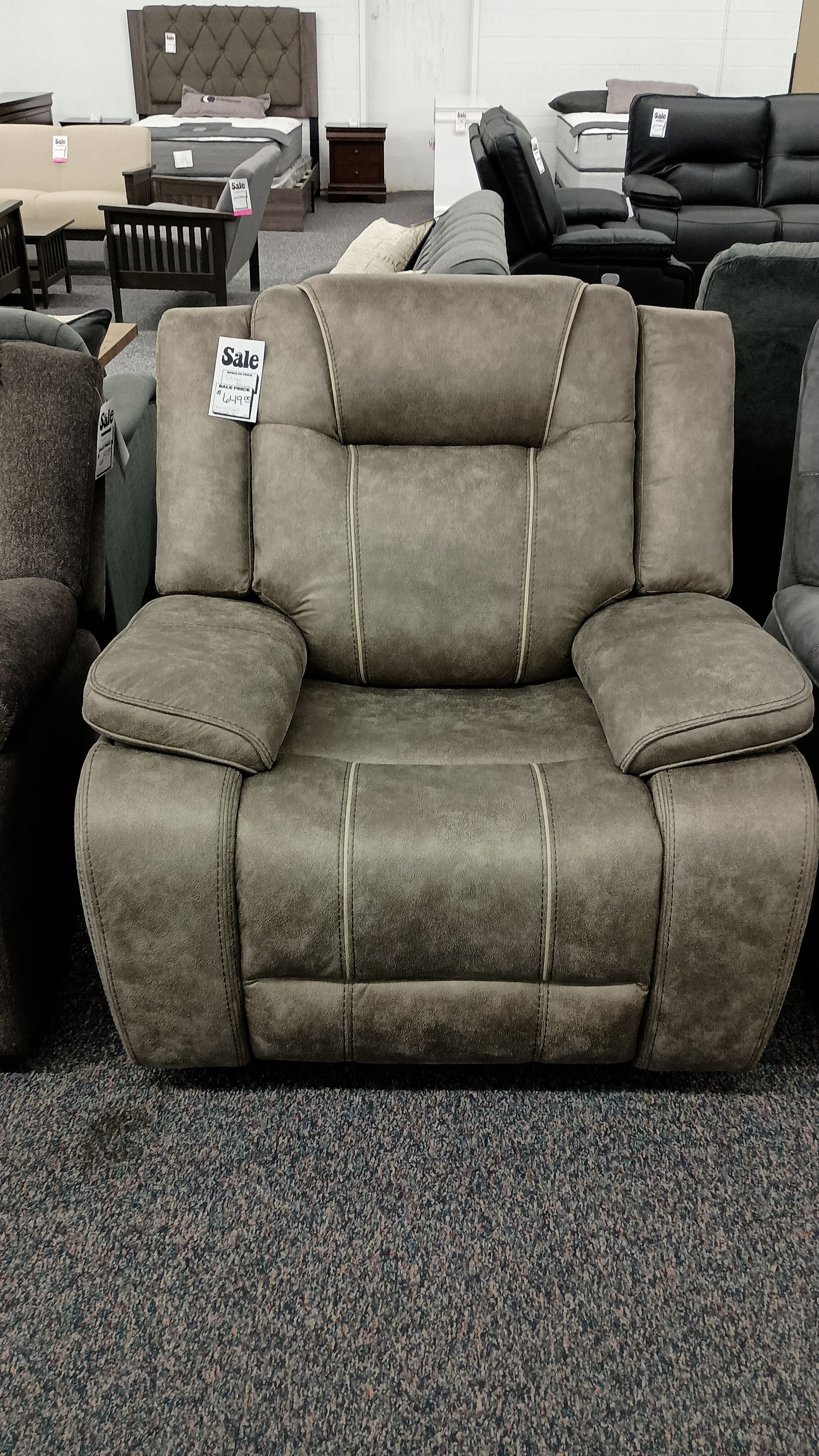 A recliner in a store with a price tag on it