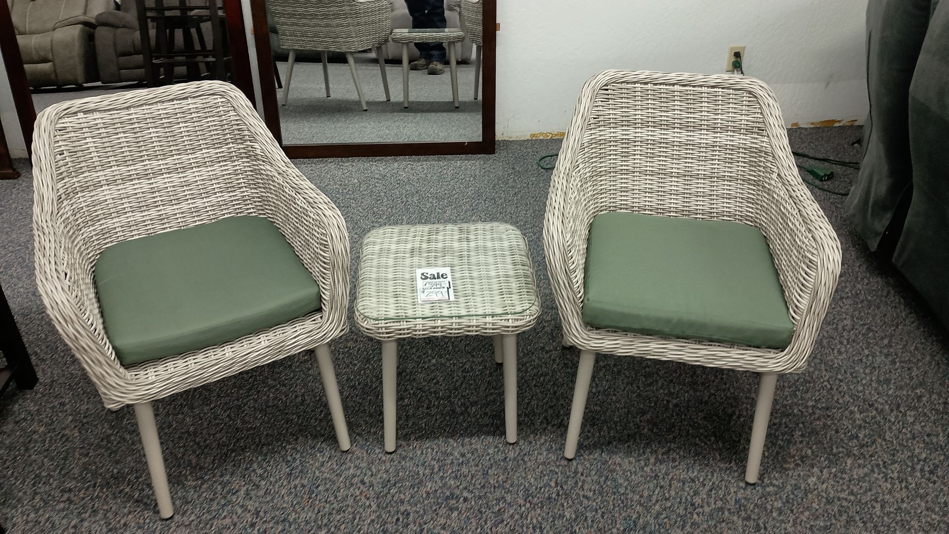 Two chairs and a table in a room with a mirror