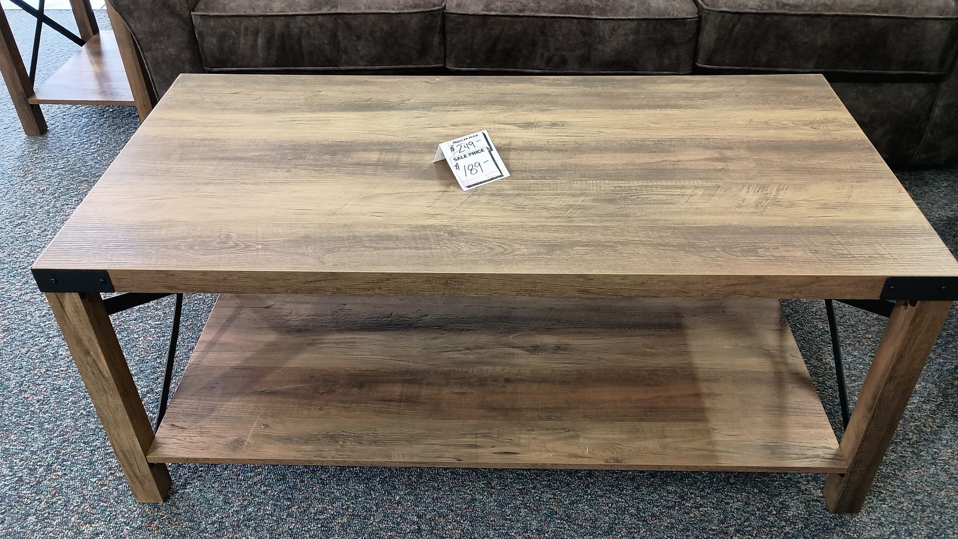A wooden coffee table with a shelf underneath it