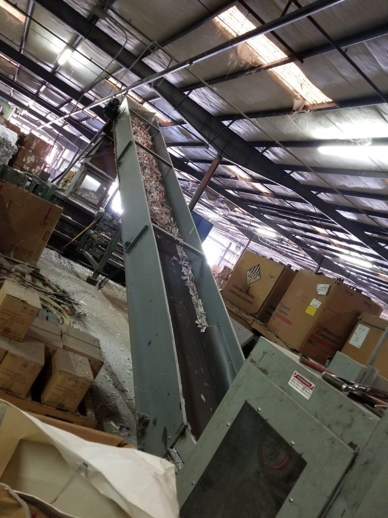 shredded paper coming down the conveyor belt