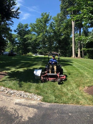 Lawn Mower On The Green Grass — Henrico, VA — Amigos Landscaping