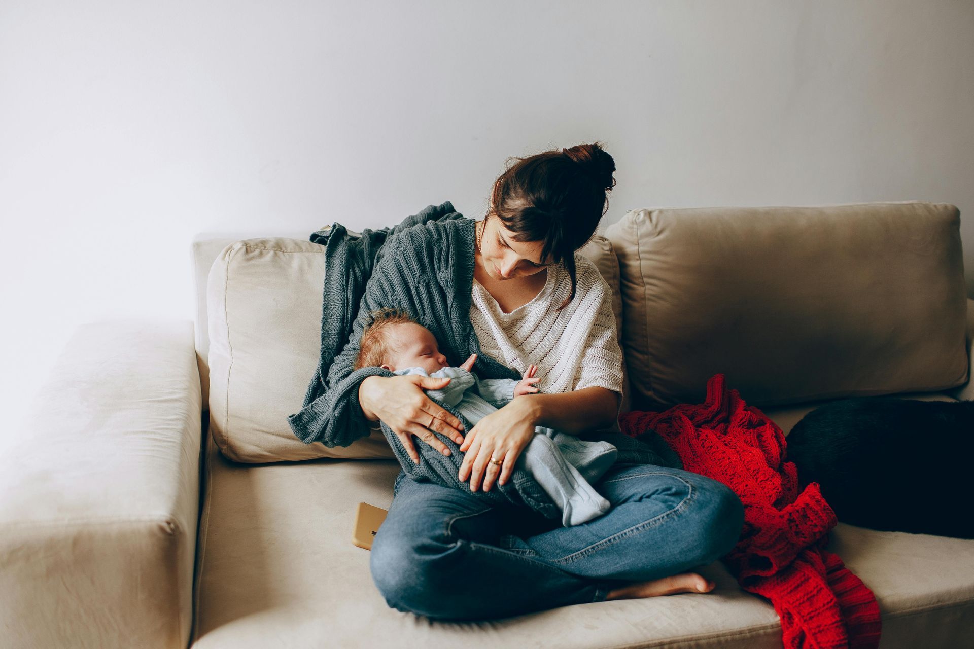 A mother holding a infant.