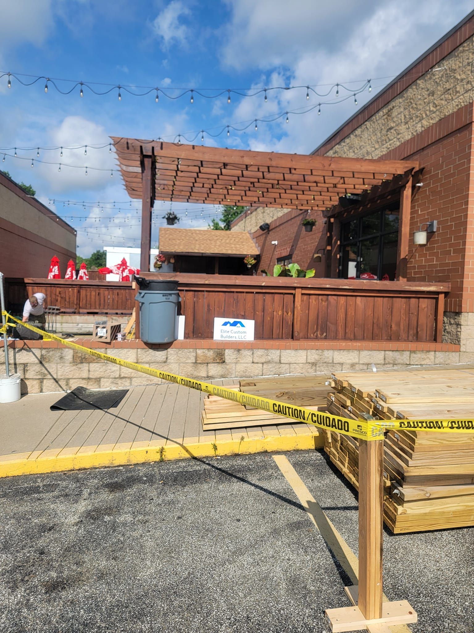 A wooden pergola is being built in front of a building.