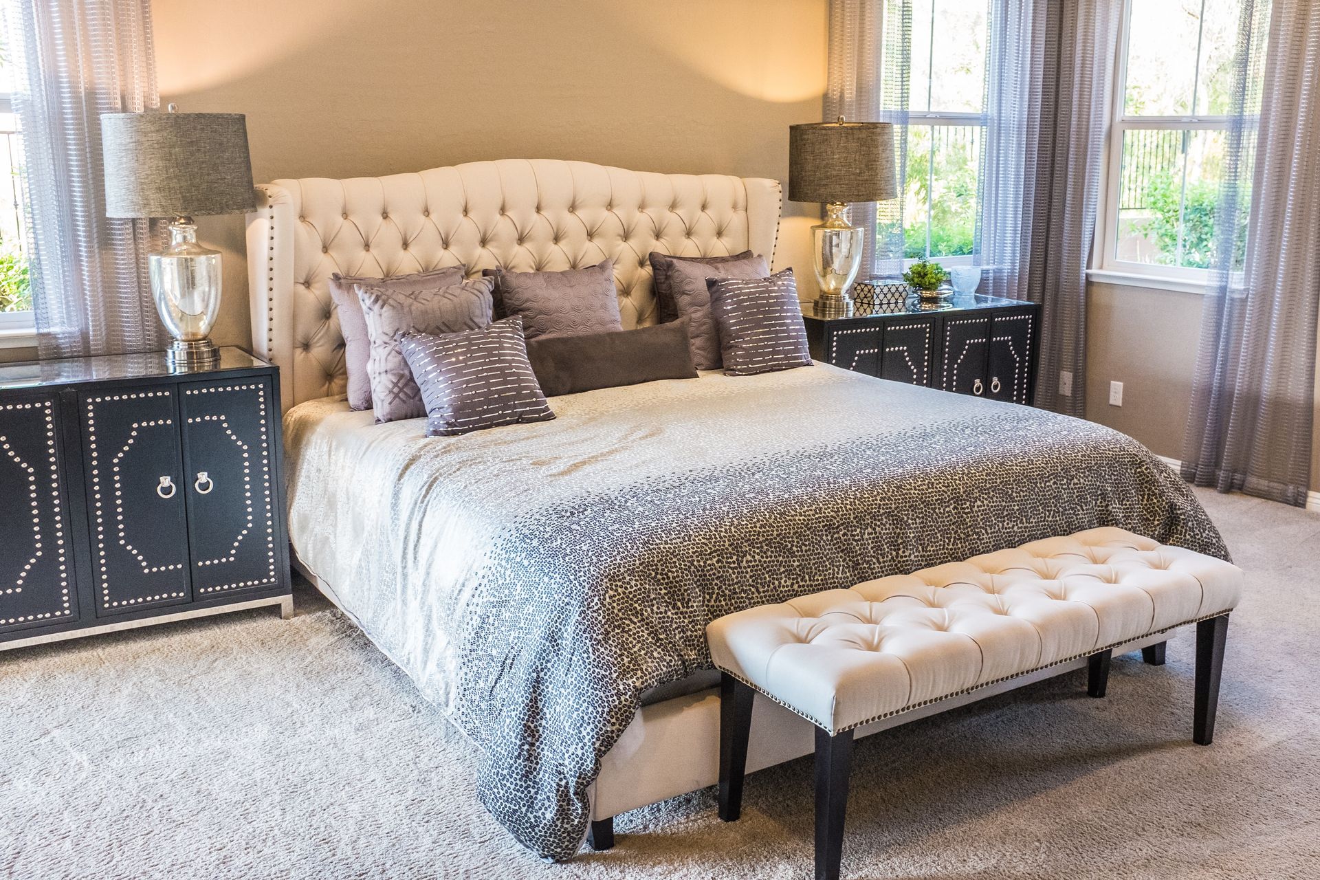 A bedroom with a large bed and a bench