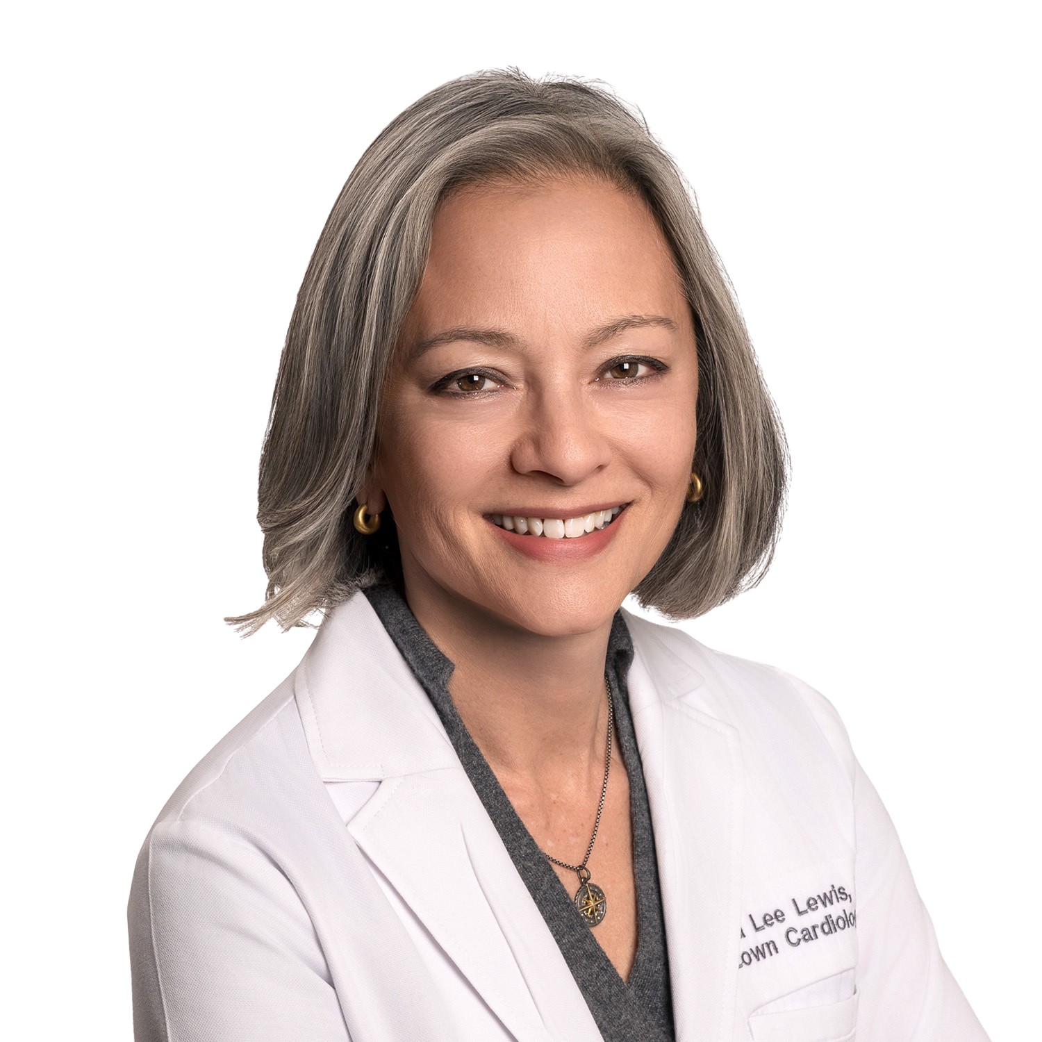 Smiling older doctor with glasses, stethoscope, white coat.