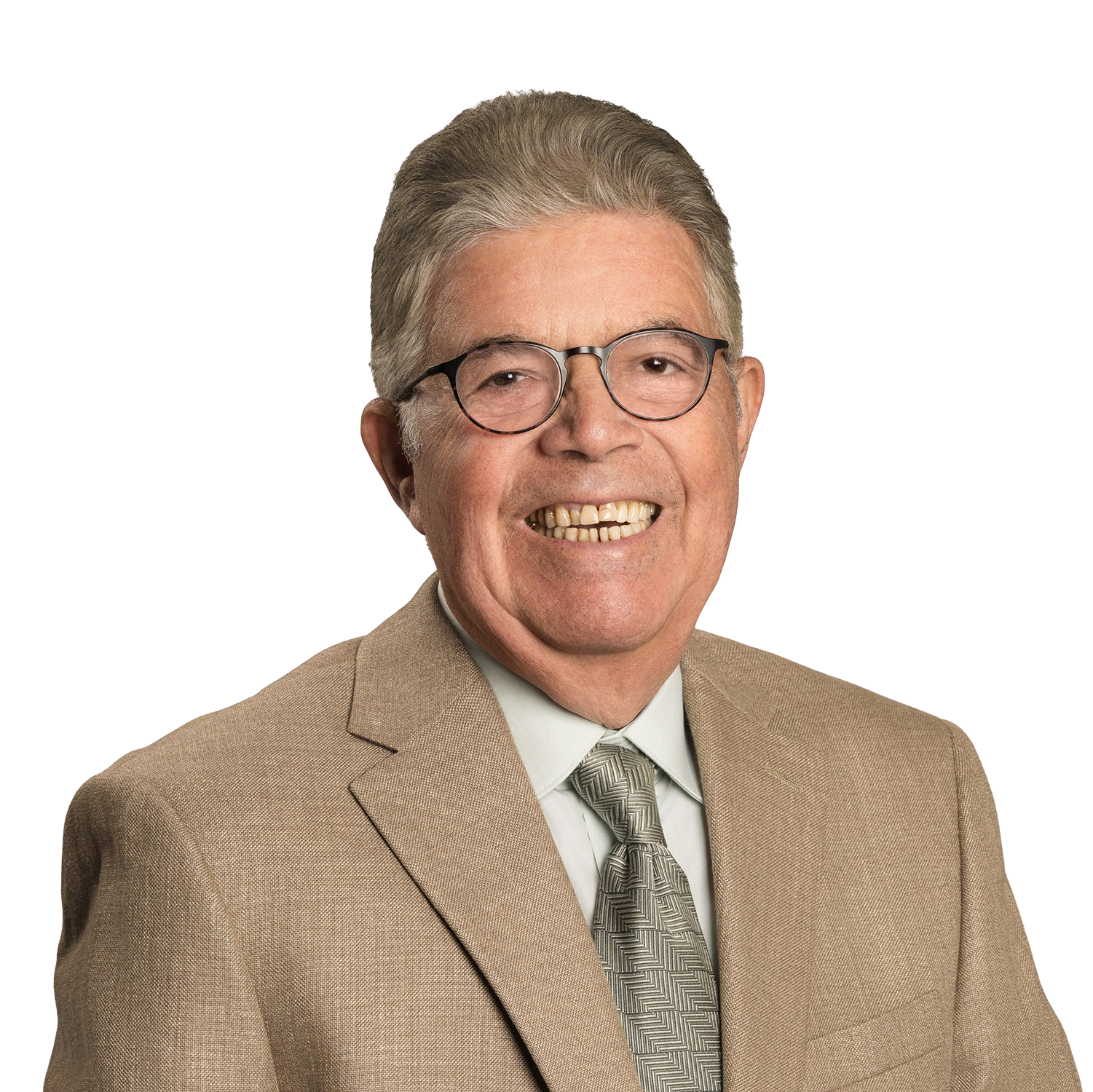 Man in glasses smiles, wearing a patterned tie and beige suit jacket.