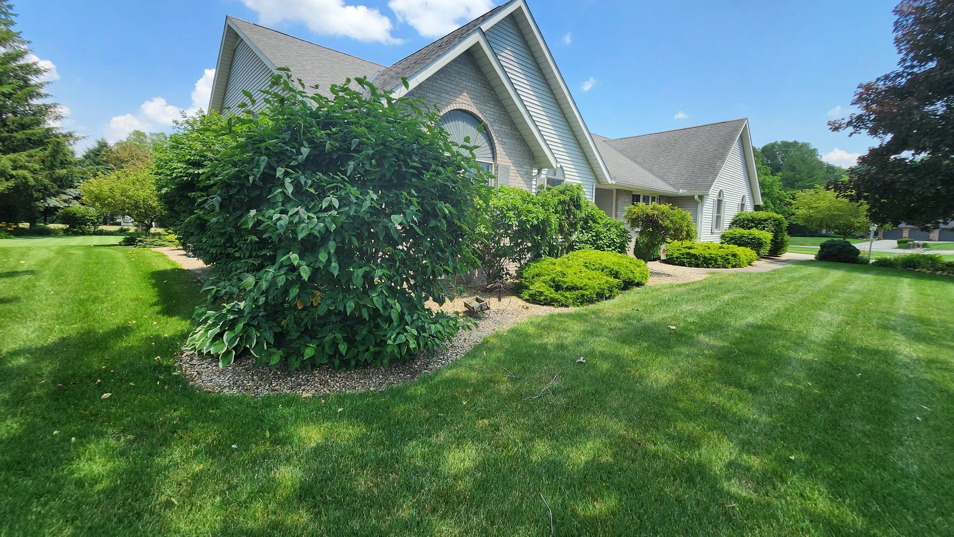 A large house with a lush green lawn in front of it.