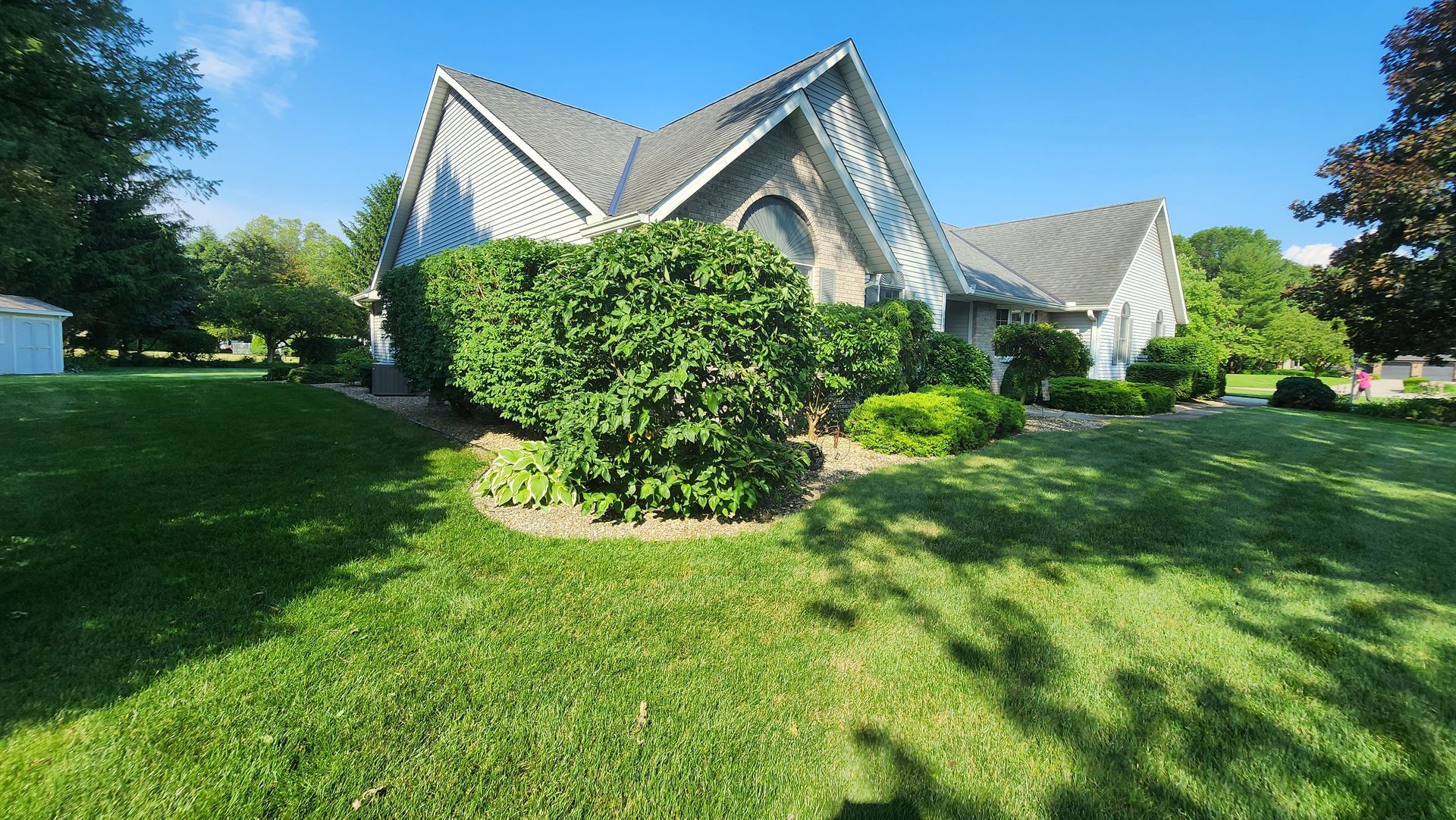 A large house with a lush green lawn in front of it.