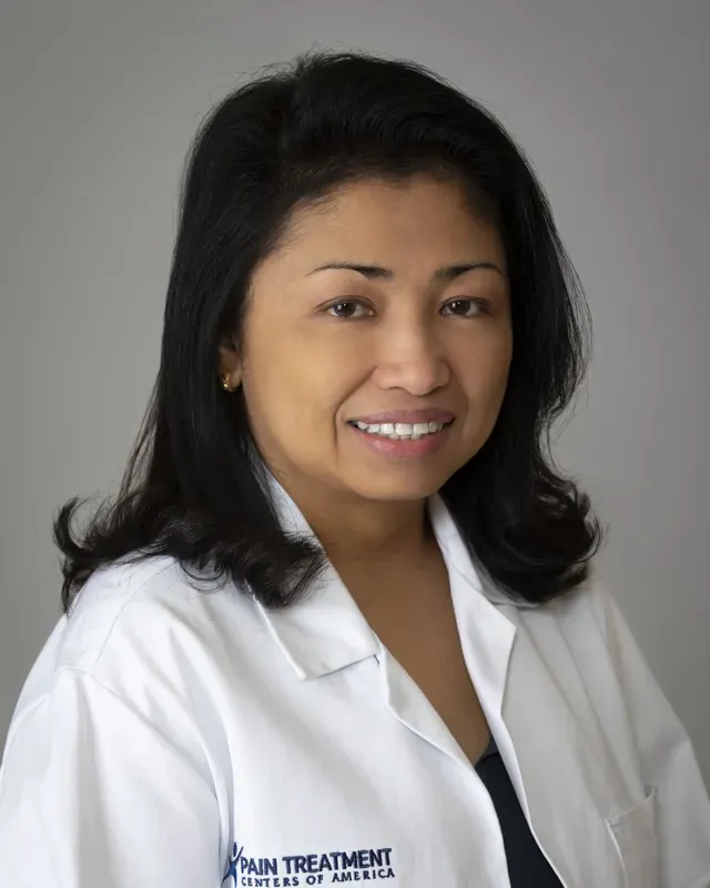A woman wearing a white lab coat with palm treatment written on it
