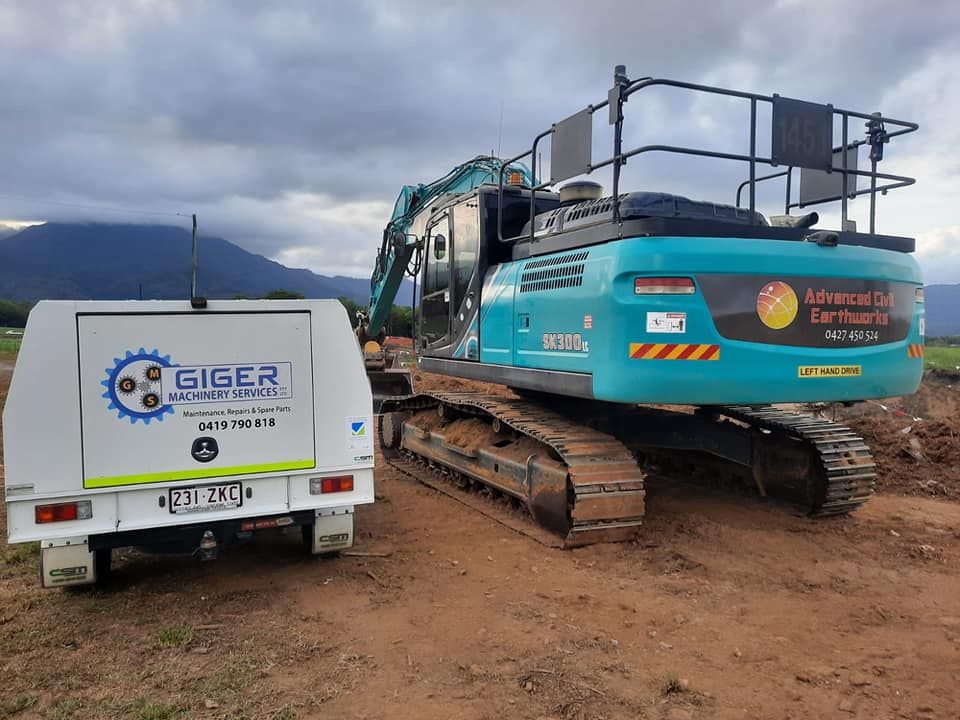 A Large Excavator is Parked Next to a Small Trailer — Giger Machinery Services in Atherton, QLD