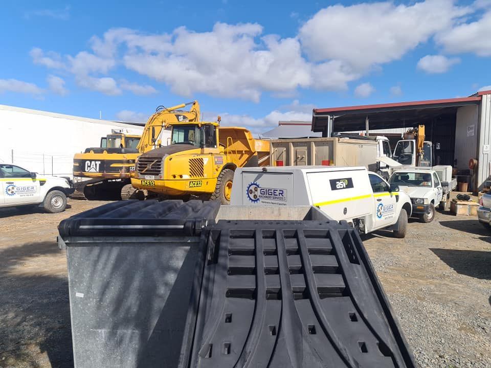 A Lot of Trucks Are Parked in a Parking Lot — Giger Machinery Services in Atherton, QLD