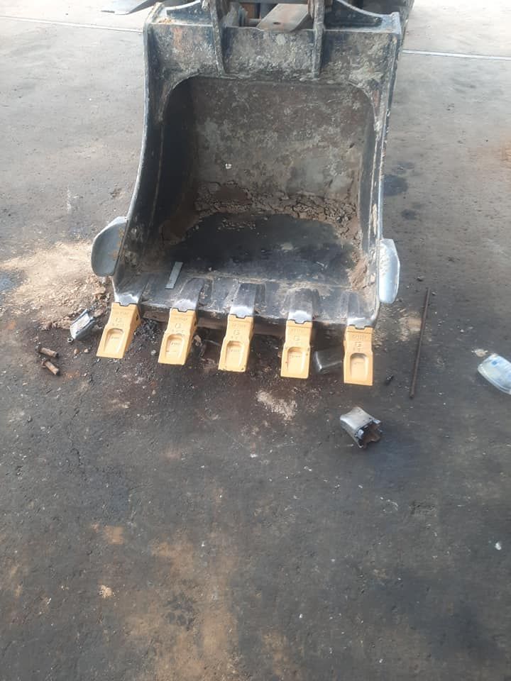 The Bucket of a Bulldozer is Sitting on the Ground — Giger Machinery Services in Atherton, QLD