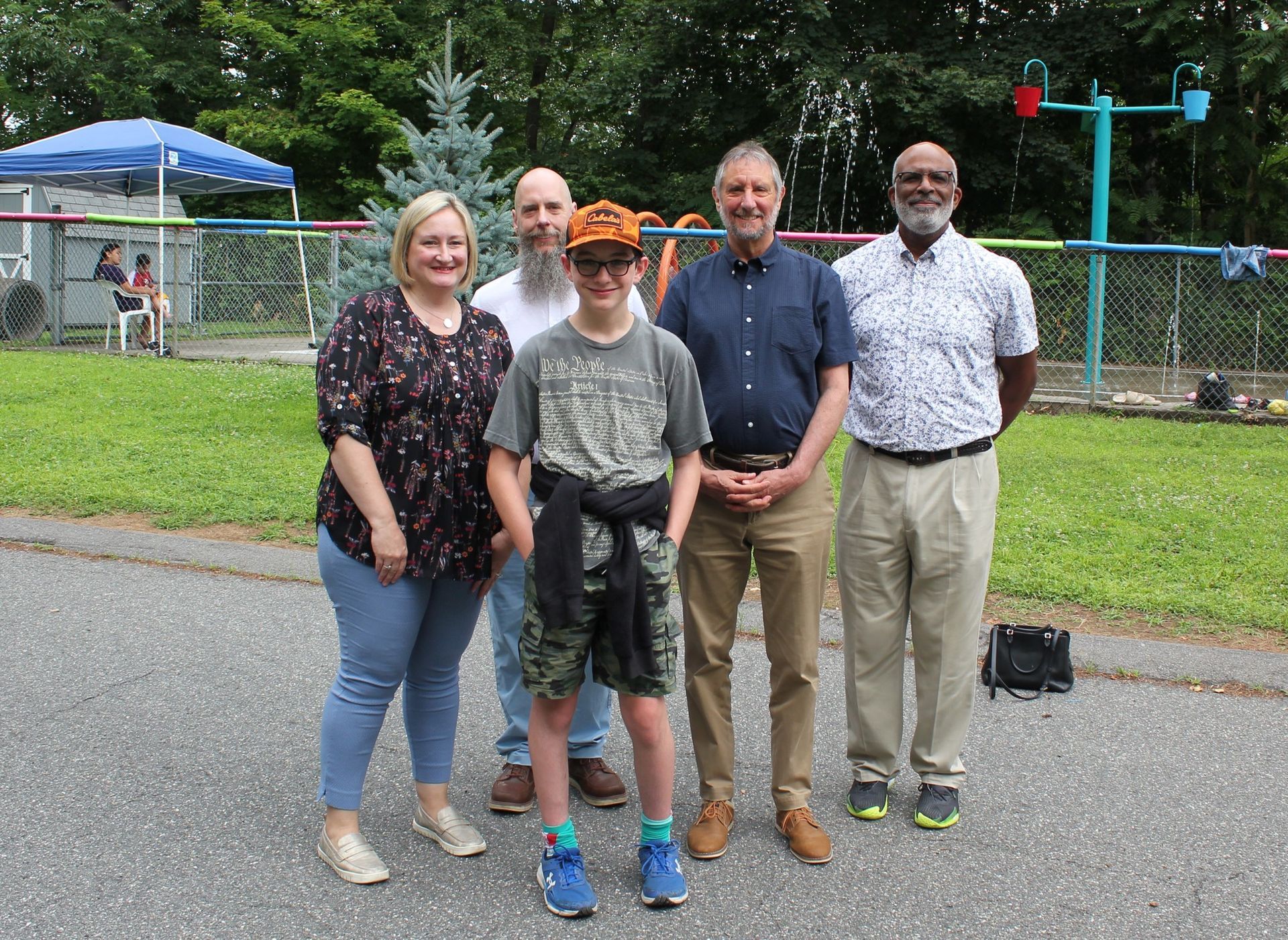 Sarah Peterson, DDS Commissioner, Brian Ross, VP Developmental Services, Steve Winn, President & CEO, Tony Boswell, Sr. VP Developmental Services, pictured with a camper.