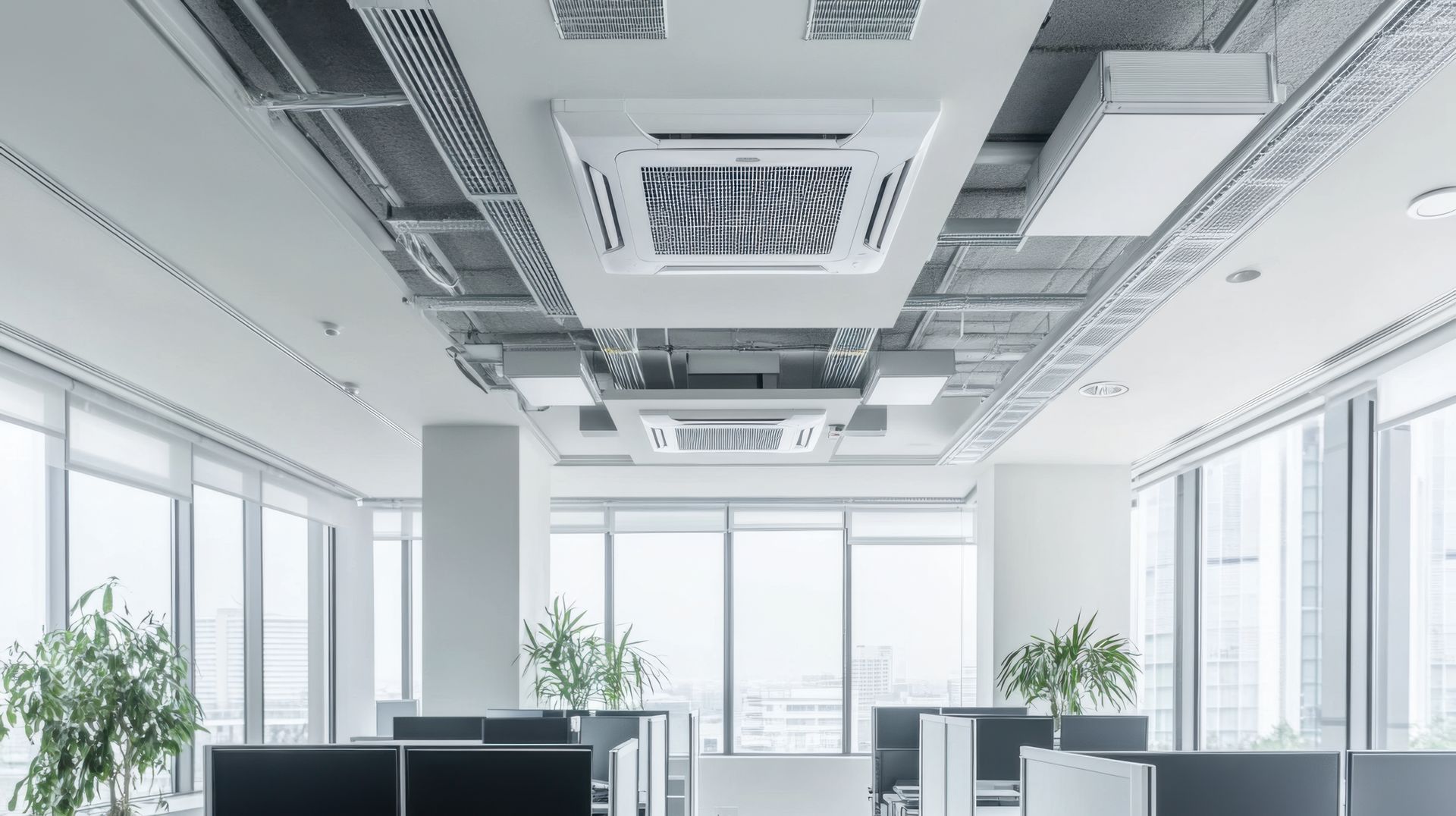 An office with a lot of windows and a ceiling fan.