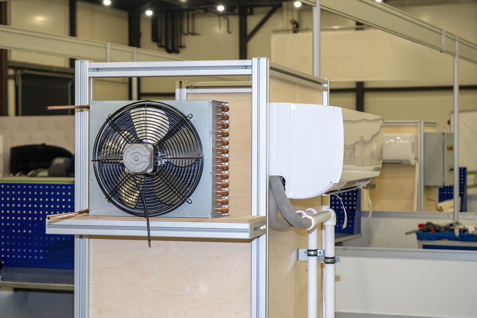 A fan is sitting on top of a table next to an air conditioner.