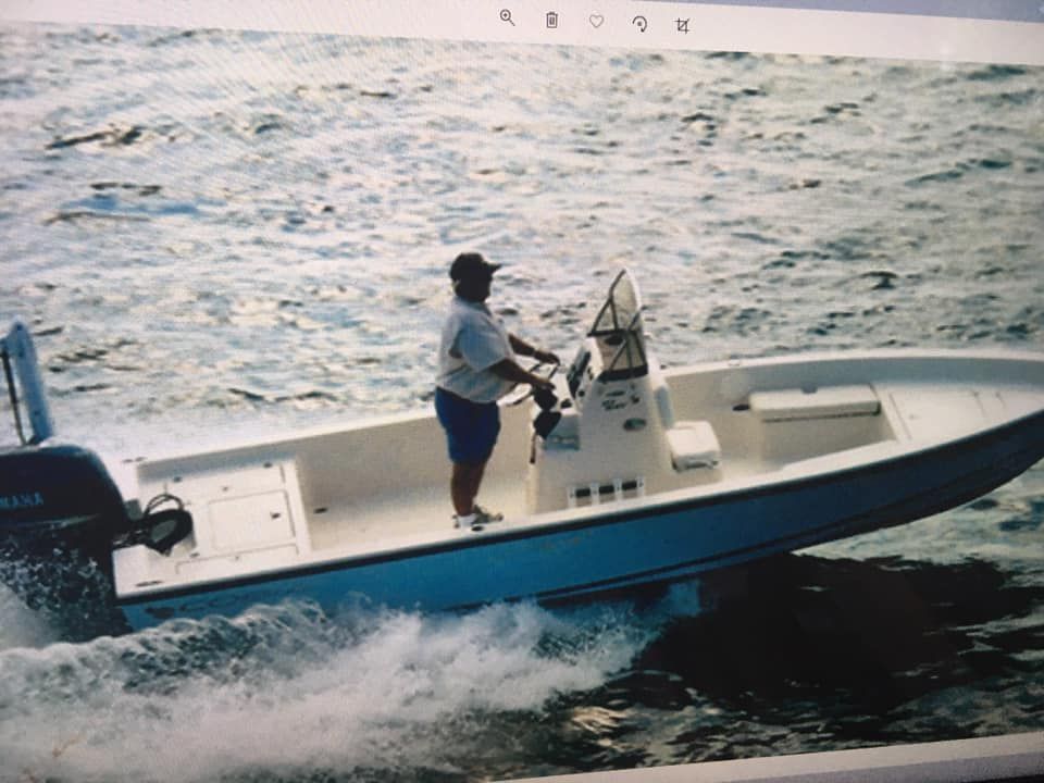 A man is driving a boat with a yamaha engine