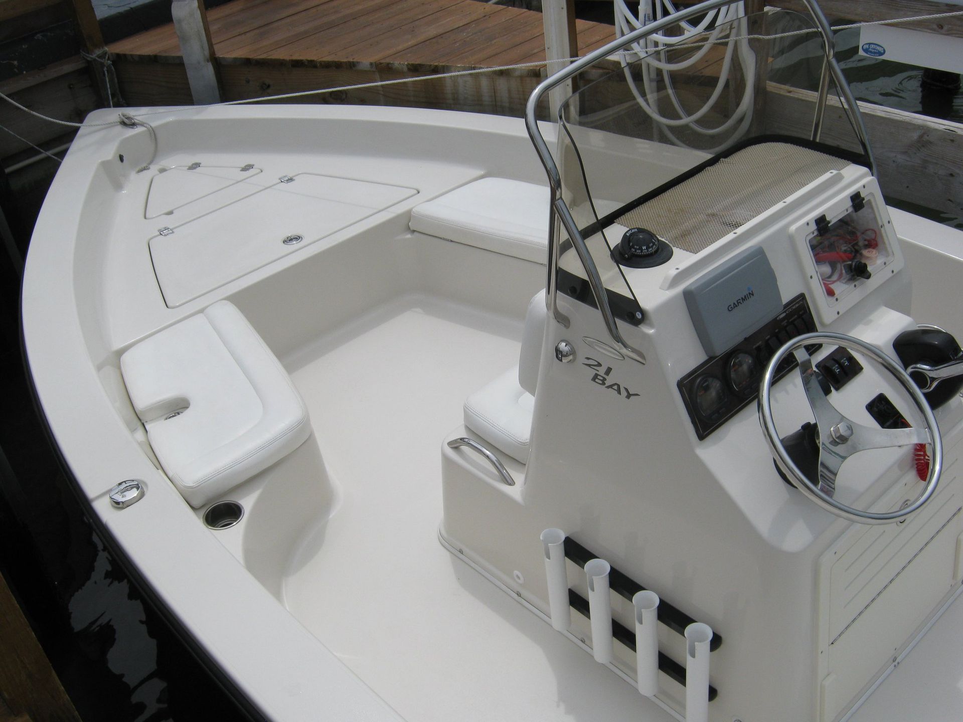 A white boat with a steering wheel that says p. lar