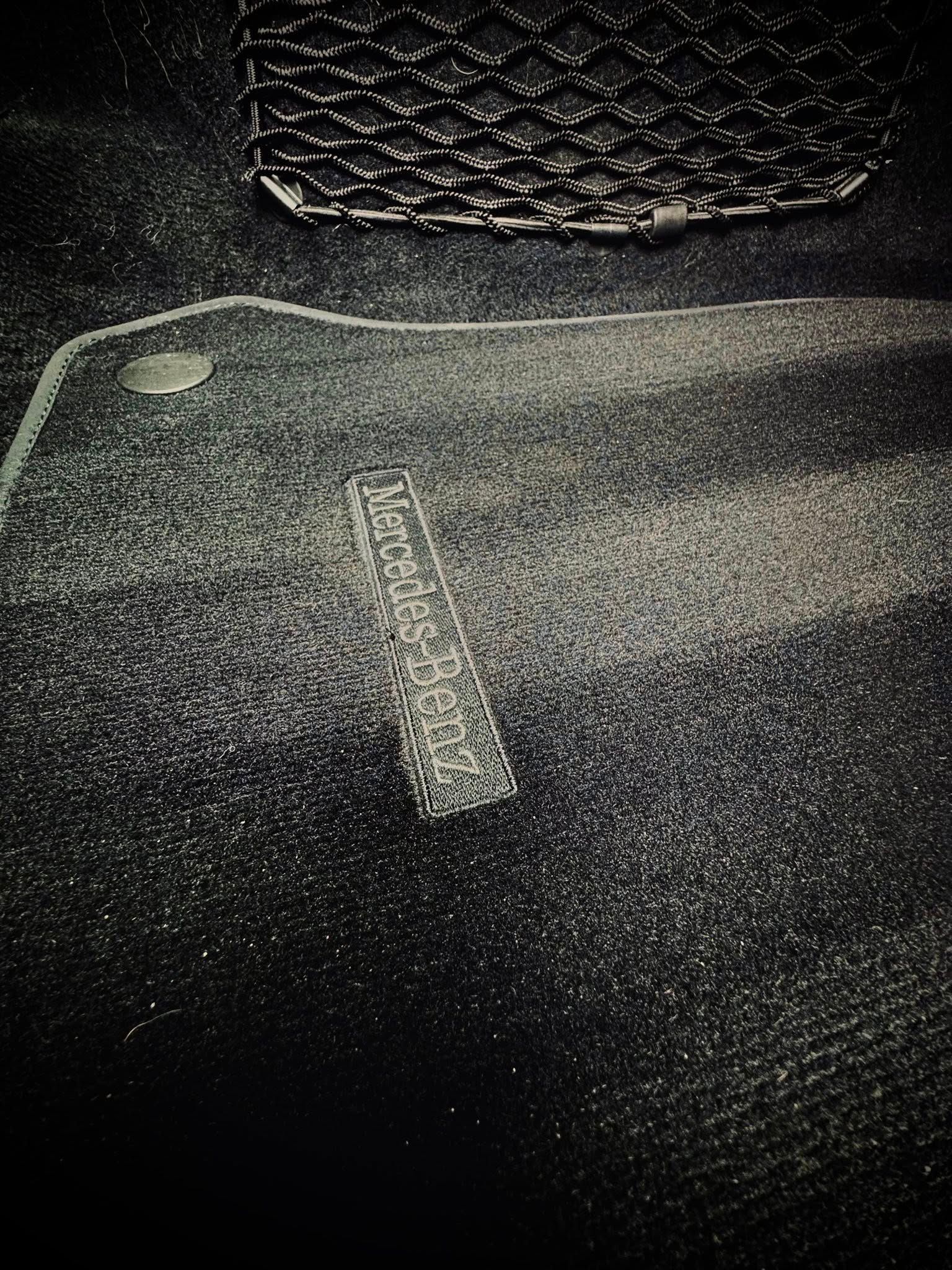 Dark fabric with a woven design at the top and a rectangular emblem near the center.