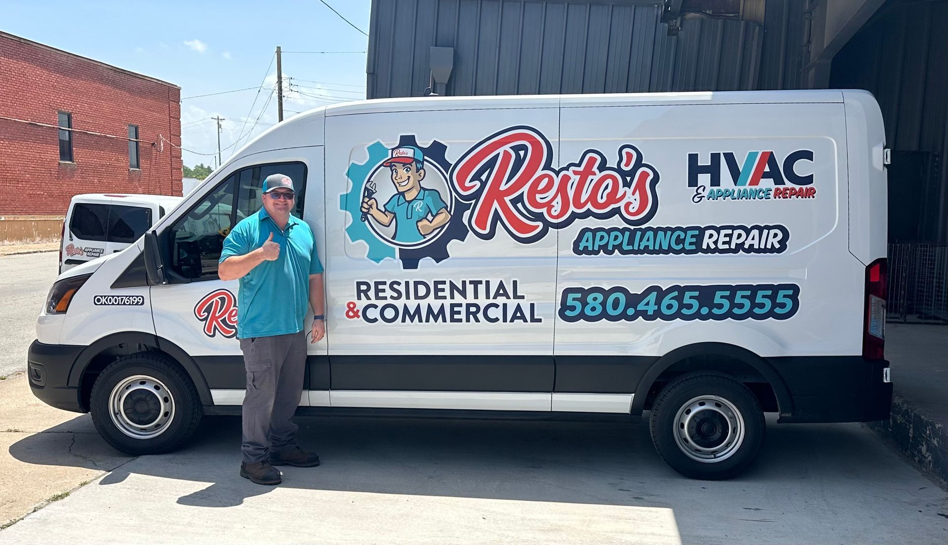 Man in teal shirt beside Resto’s HVAC service van with company logo and phone number
