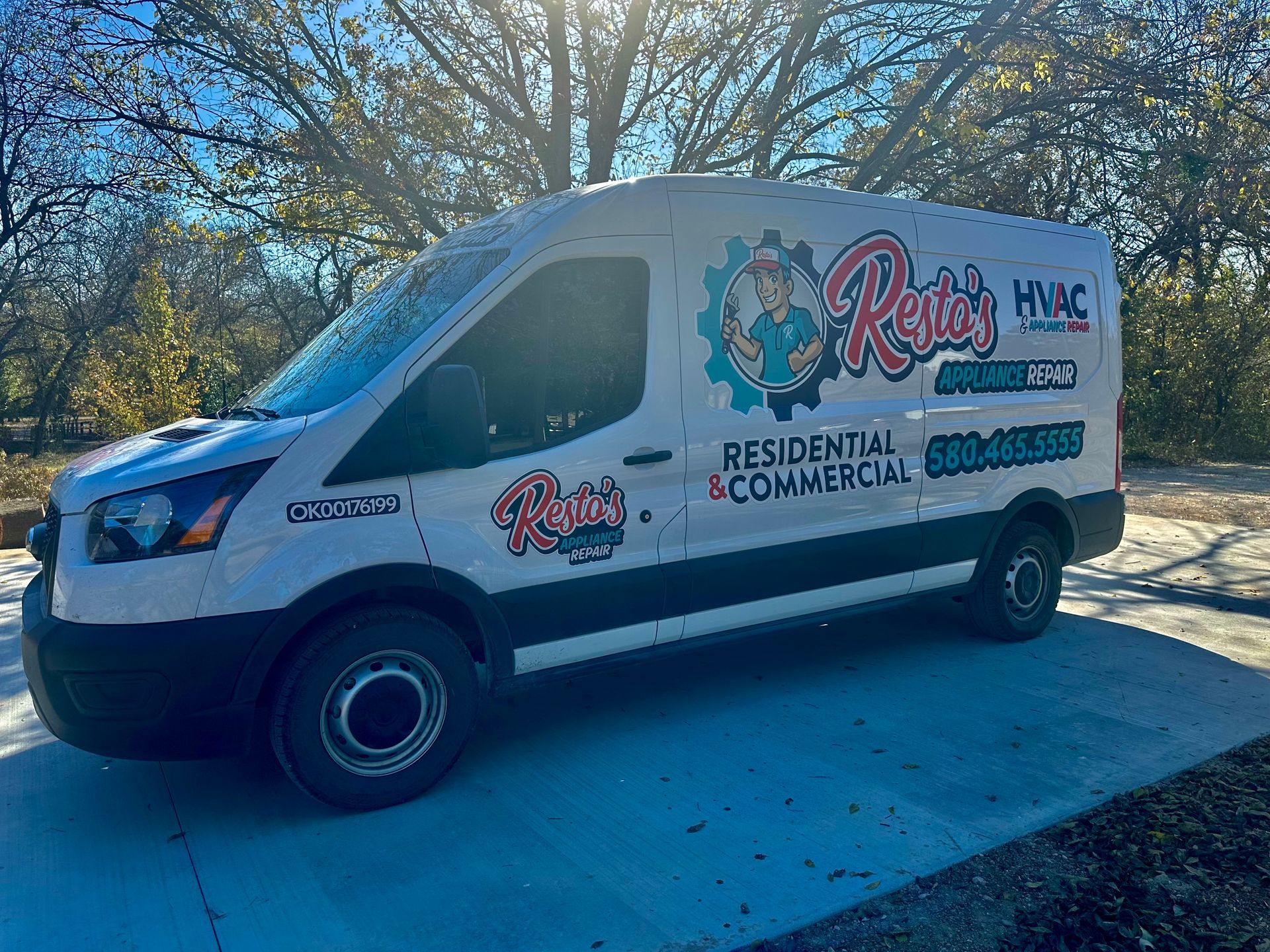 White service van with “Randy’s HVAC” lettering parked on a sunny street.