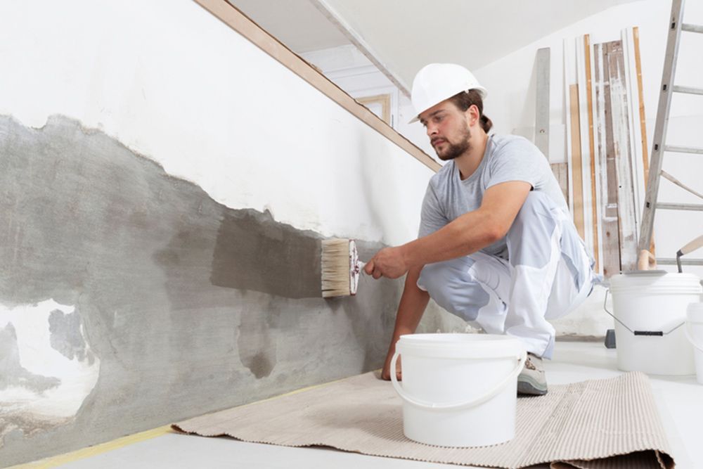 Man painting the walls inside a home — Interior Painting in Maryborough, QLD