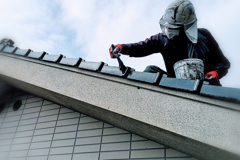 Man painting the side of the roof — Interior Painting in Hervey Bay, QLD