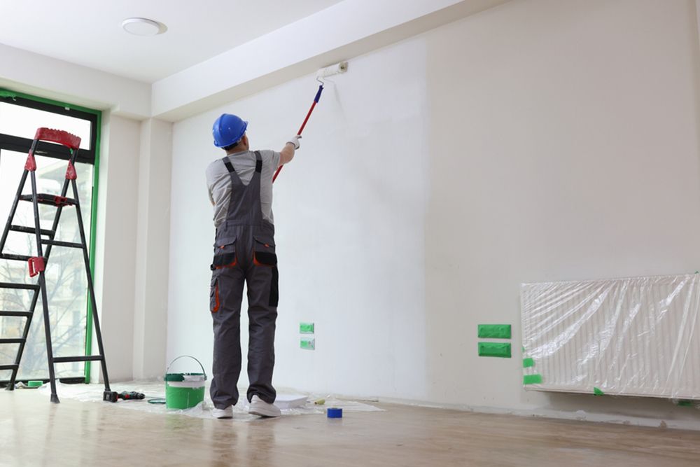 Man painting the walls white — Interior Painting in Hervey Bay, QLD