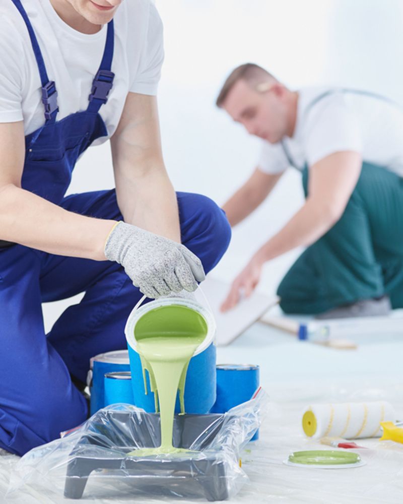 Man pouring paint into a container — Painters in Fraser Coast, QLD