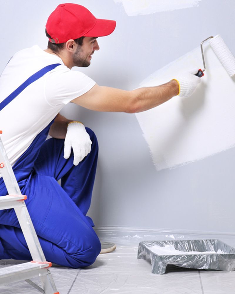Painter smiling while painting the wall — Interior Painting in Fraser Coast, QLD