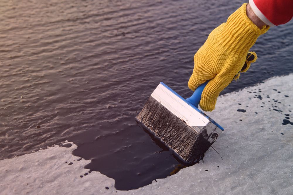 Person painting the floor using a large paint brush — Interior Painting in Hervey Bay