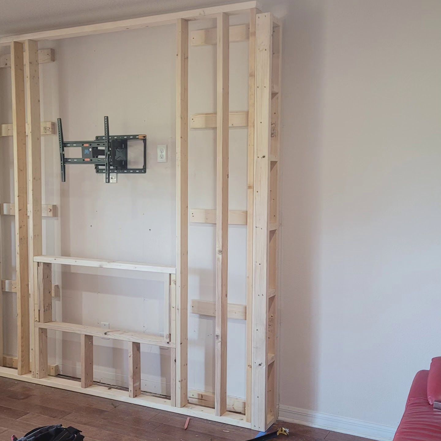 A living room with a tv mounted on the wall.