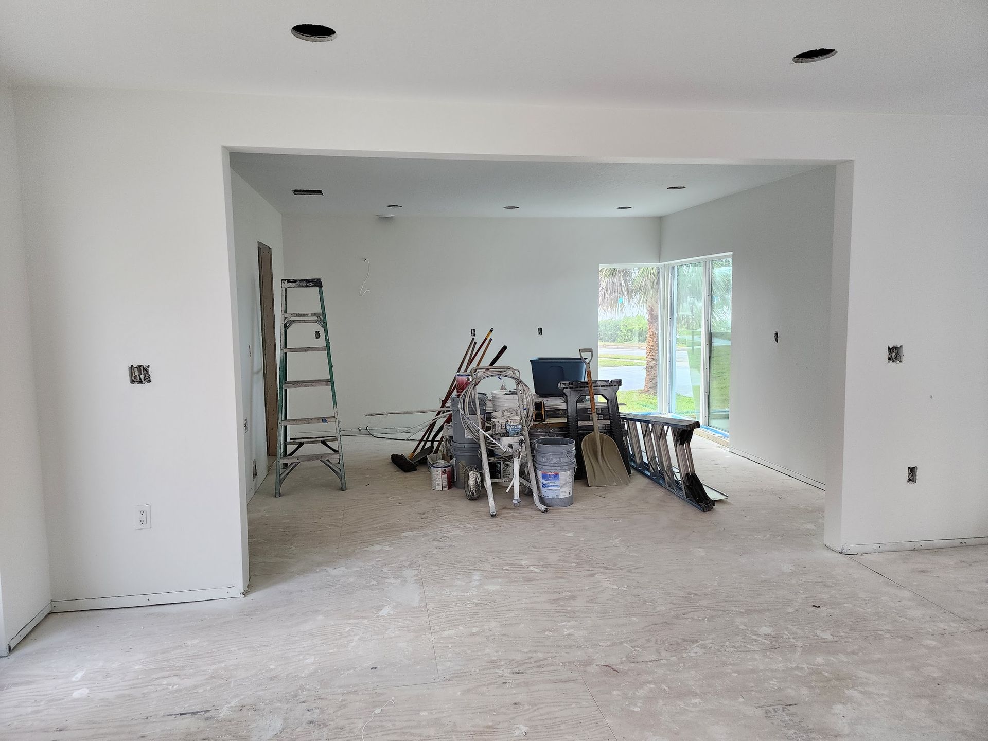 A room that is being remodeled with a lot of tools on the floor.