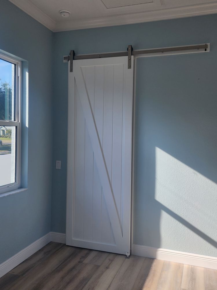 A room with a sliding barn door and a window