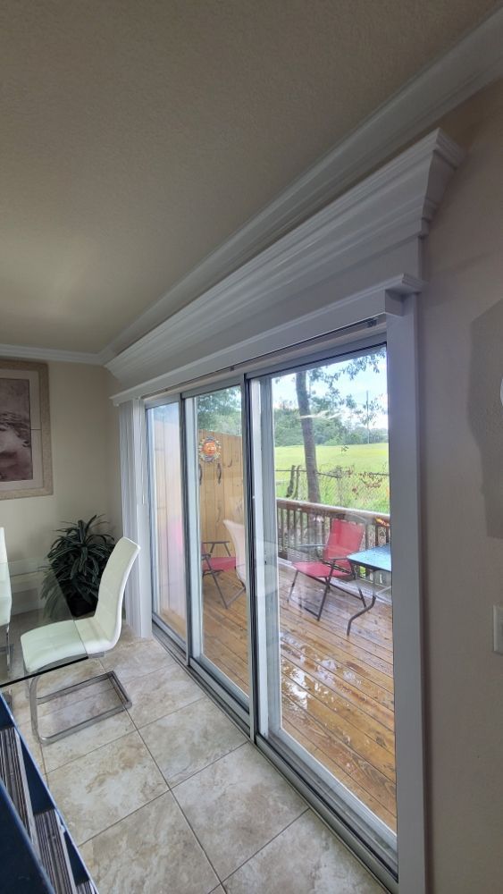A living room with sliding glass doors leading to a deck.