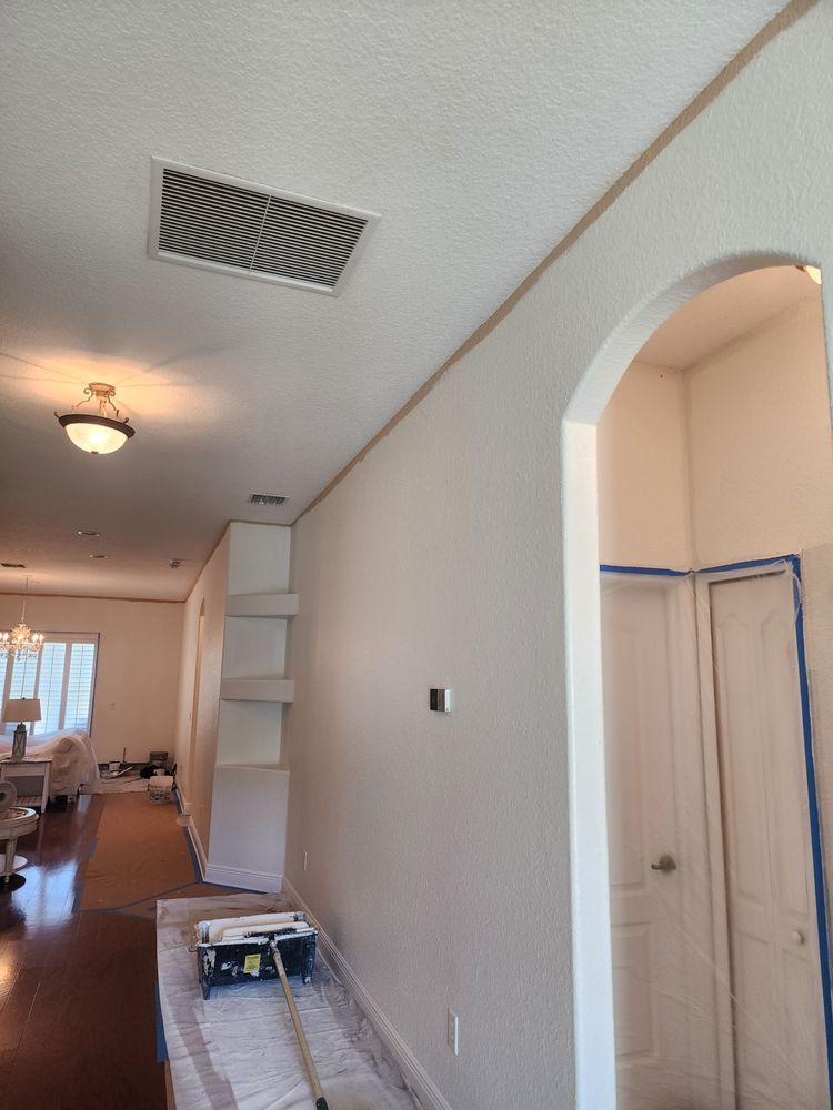 A room with white walls and a ceiling fan.