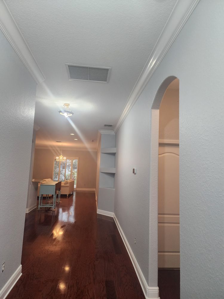 A hallway leading to a living room and dining room