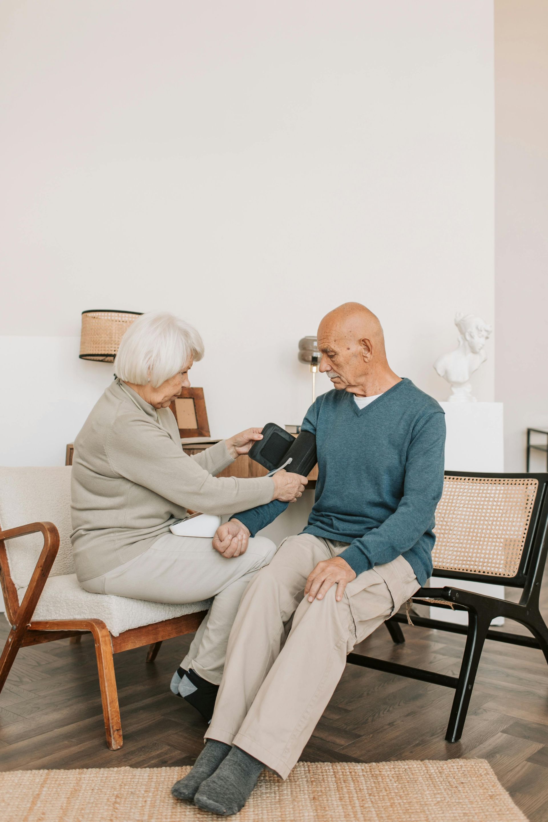 An elderly man getting his blood pressure measured.